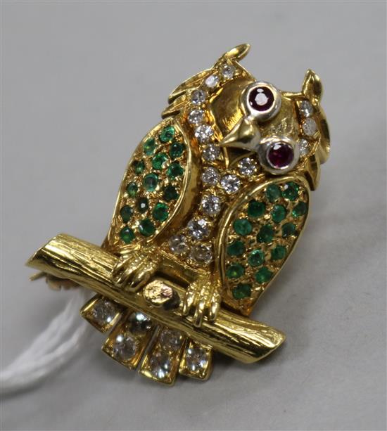 A yellow metal and gem set novelty brooch modelled as an owl perched on a branch with moving eyes, 28mm.